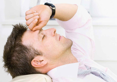 A business man tries to rest in the midst of a bout of ringing in his ears